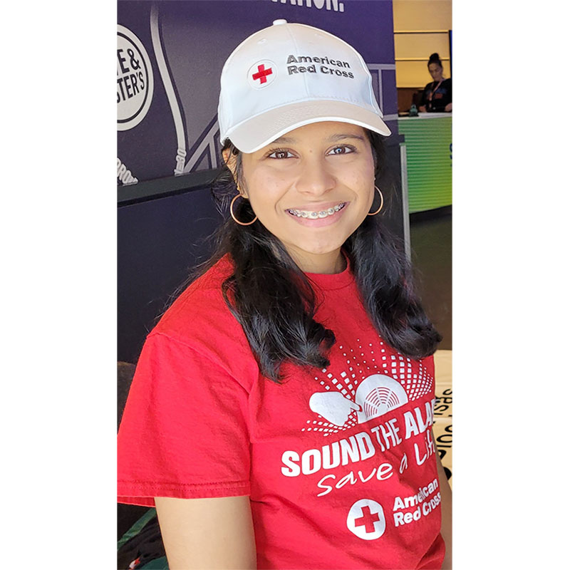 Ananya Uddanti wearing Red Cross hat and Sound the Alarm shirt