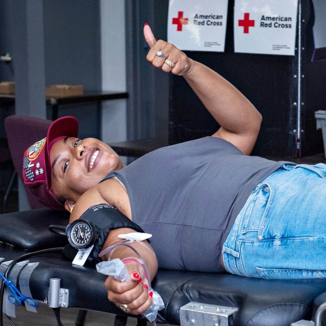 blood donor holding thumbs up
