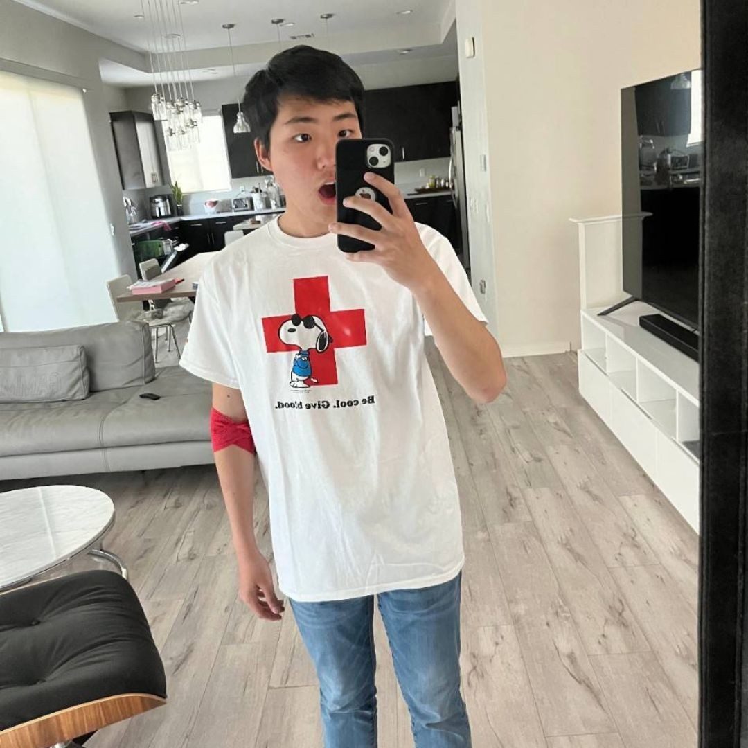 andrew chun with red cross snoopy shirt
