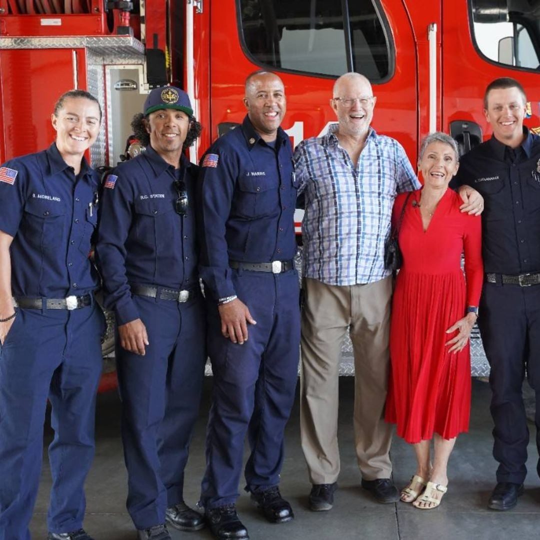 steve and annette cline smiling with firefighters