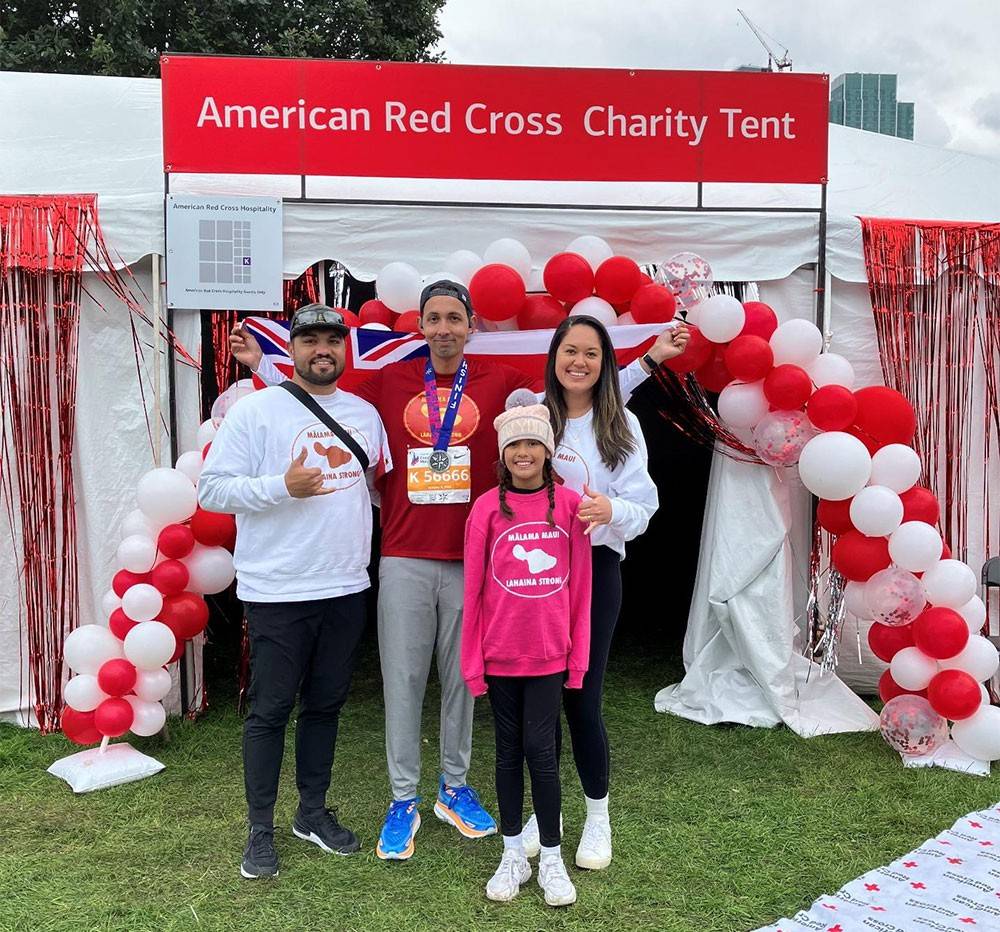 Nate Kahaialii with famliy at Chicago Marathon in front of American Red Cross Charity Tent
