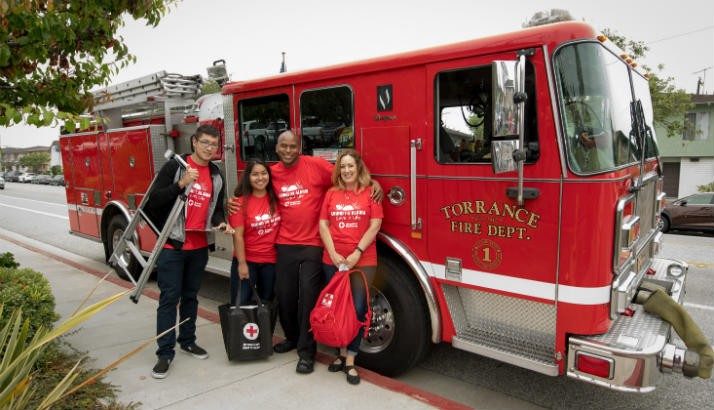 group of volunteers in front of fire truck