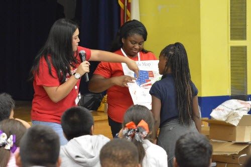 Red Cross volunteers teaching class to youth