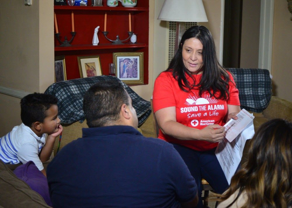 Red Cross volunteer going over safety plan with family