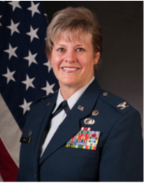 woman in military uniform with american flag behind her