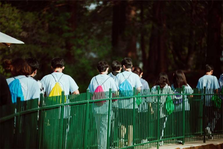 Youth walking with colored backpacks