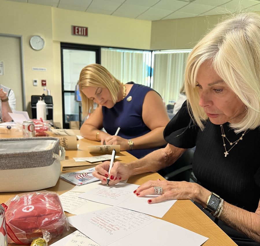 two tiffany circle members writing cards for veterans 