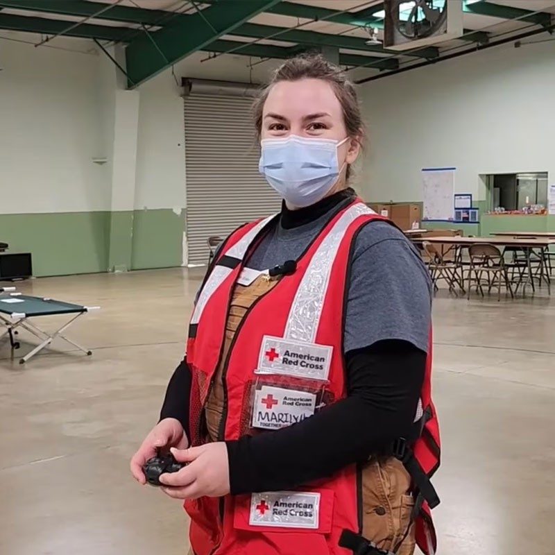 Marilyn Violas with Red Cross vest and mask.
