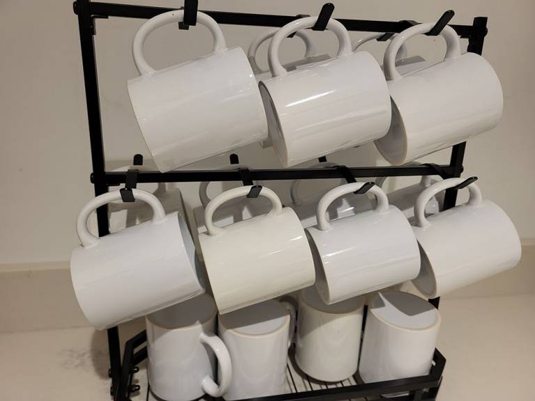 Ceramic mugs on a rack