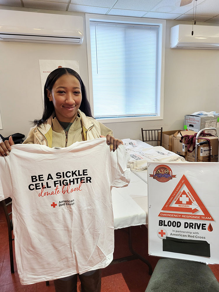 Zoriah Ashby stands with her t-shirt after donating blood.