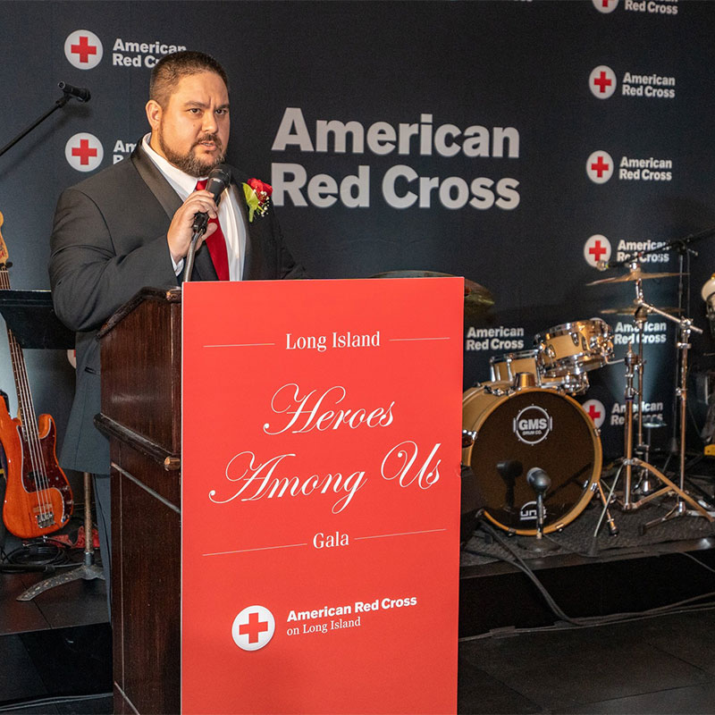 Sammy Chu speaking at podium at a Red Cross event
