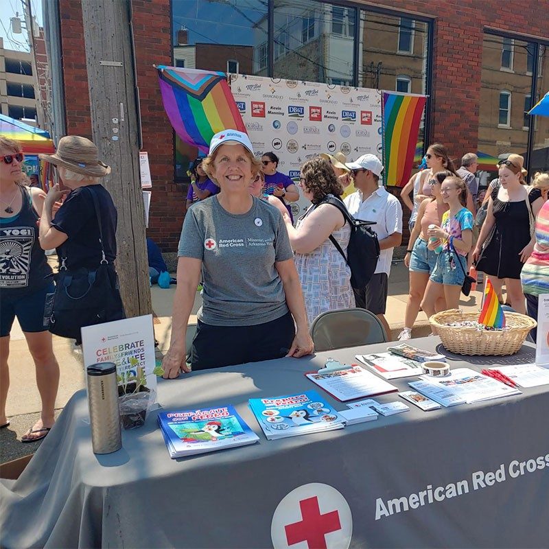 Red Cross volunteer providing fire safety education and Red Cross information at Dubuque Pride.