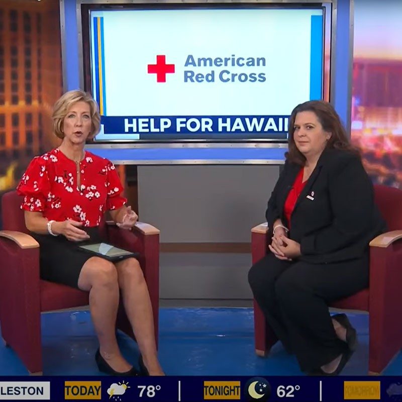 Anchorwoman and Red Cross volunteer talking