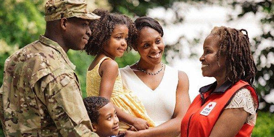 Military member, woman, two children and Red Cross volunteer