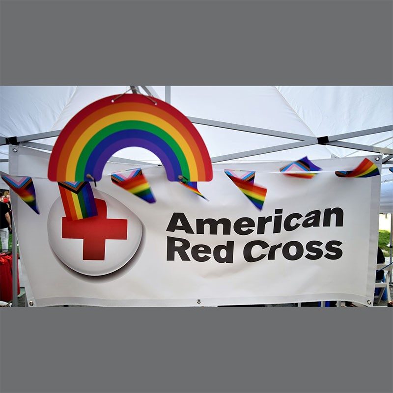 American Red Cross banner and PRIDE flags.