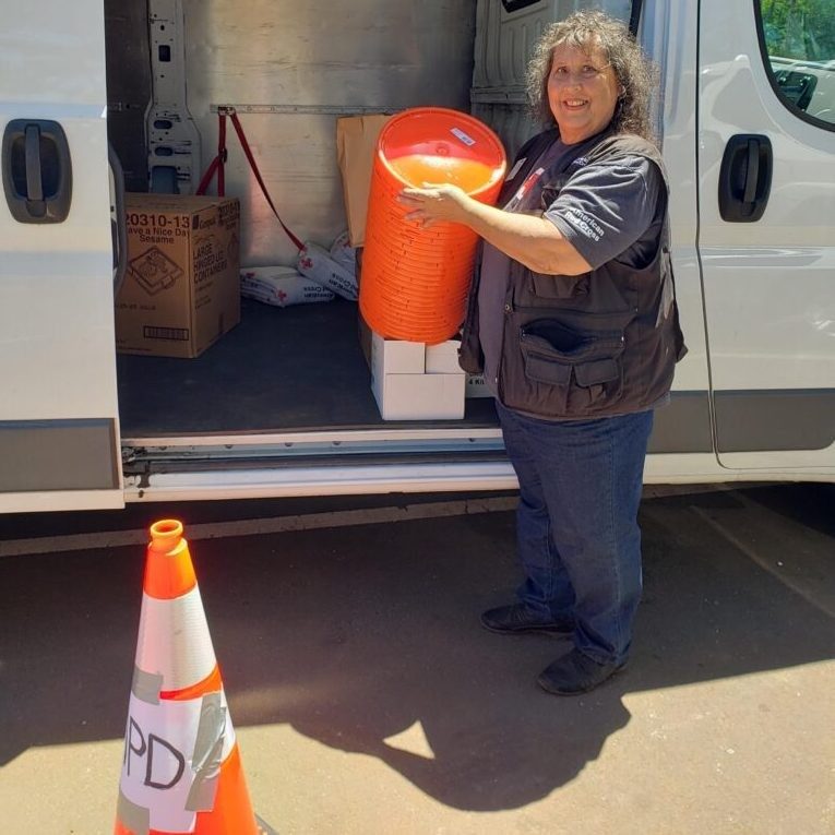 Volunteer Julia Bishop loading an emergency response vehicle