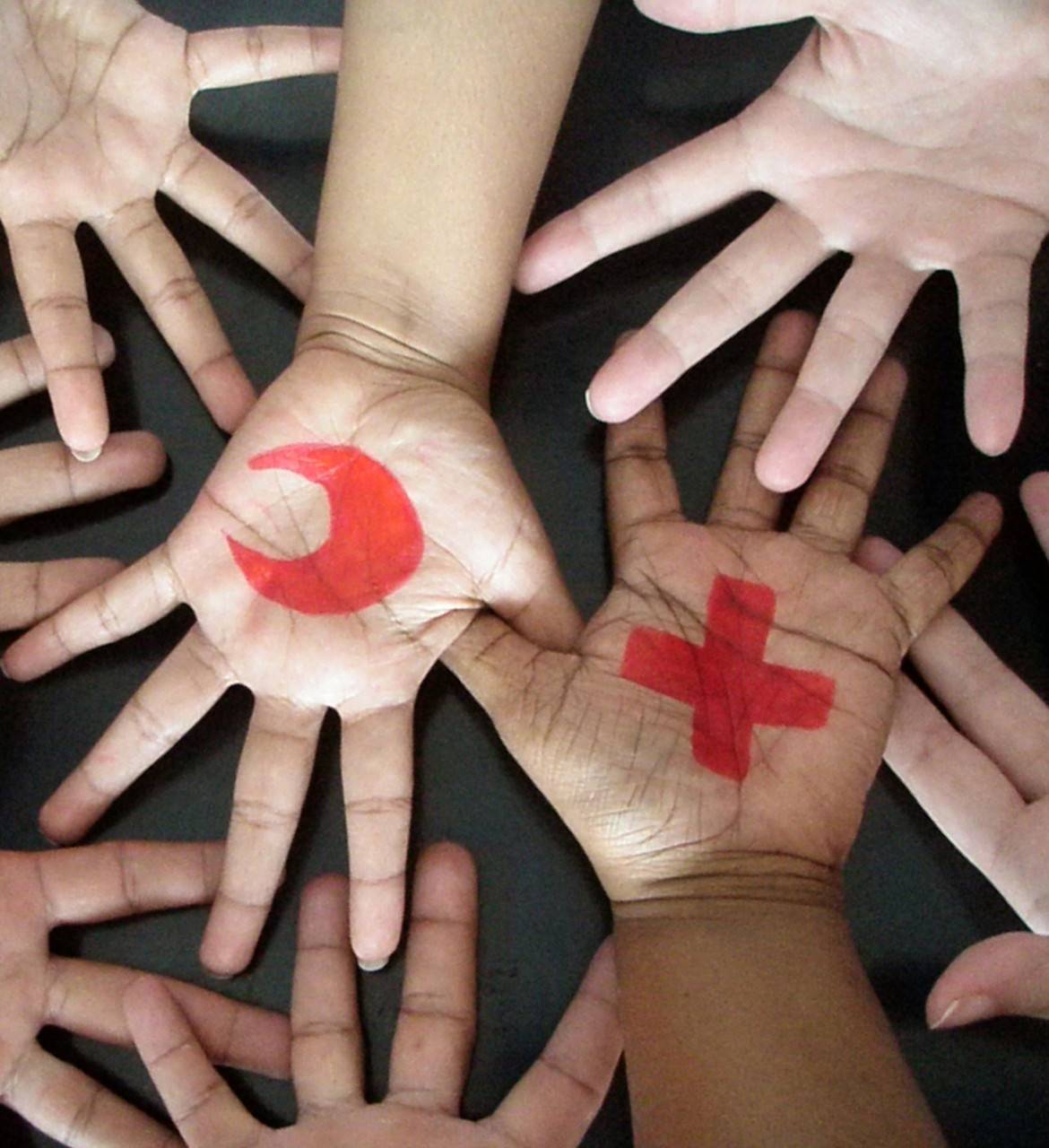 April 30, 2009. Male', Maldives. Red Cross and Red Crescent symbols painted on hands of American Red Cross Maldives staff members. Photo by Salva Ahmed/American Red Cross