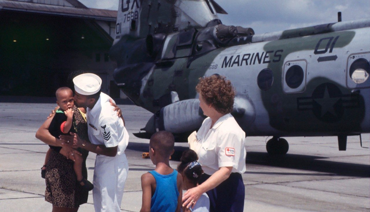 marines plane and military members embracing family