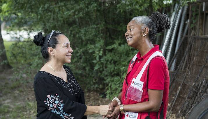 Cheryl Burton, a volunteer with the American Red Cross, speaks with Maria Rutila Acevedo.