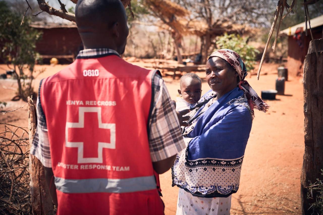 Kenya Red Cross volunteer works with mom and baby