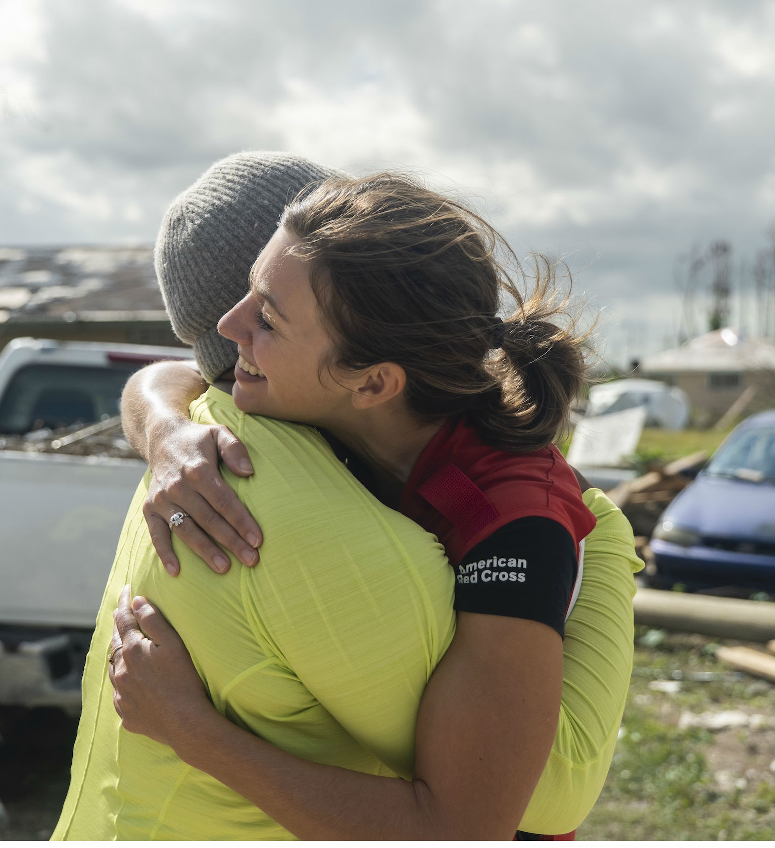 Red Cross volunteer hugging another person