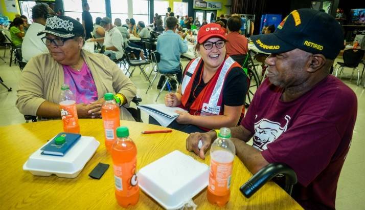 Ruth Johnson and Creston Callis, a US Army Veteran, speak with a Red Cross worker