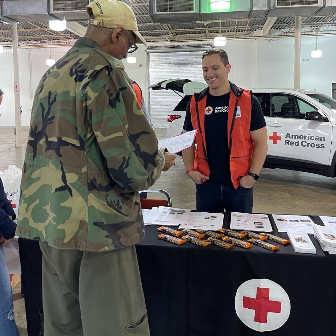 veteran and red cross volunteer at red cross table