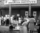 Old black and white photo showing volunteers participating in a week-long disaster training institute 