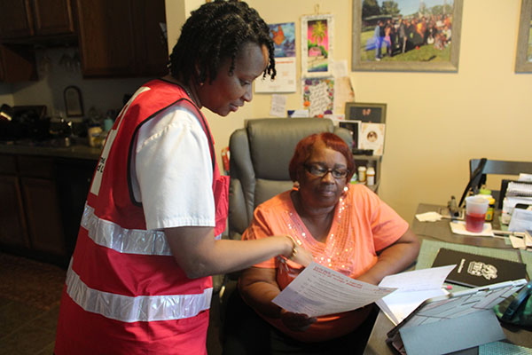 Red Cross volunteer going over escape plan with resident