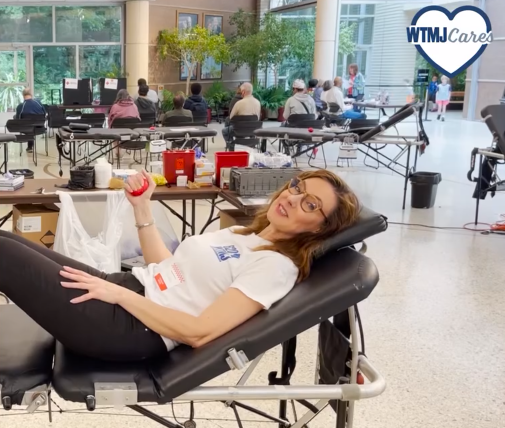 A person laying in a chair giving blood
