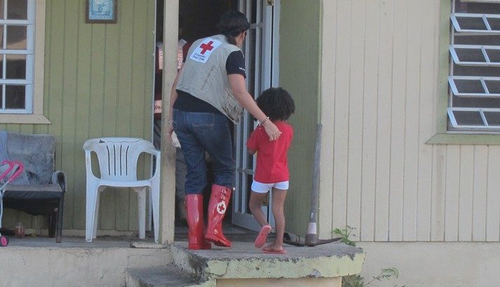 red cross volunteer and young girl