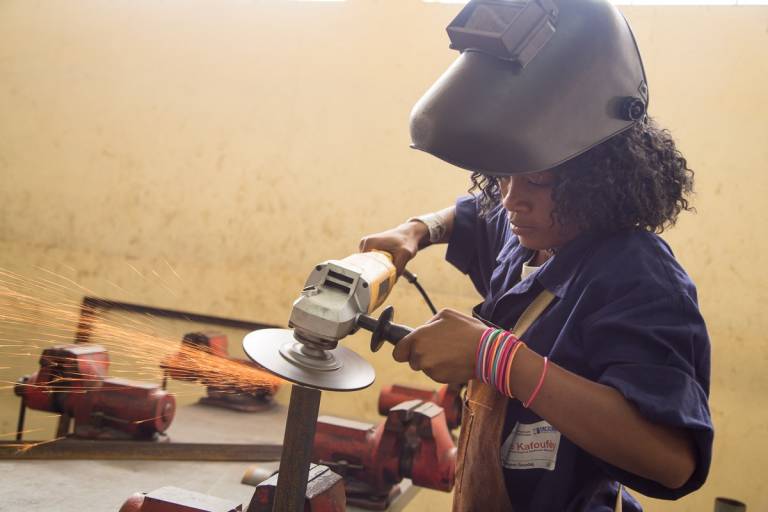 Robin Yevline practices metal work at a professional training center in Port-au-Prince, Haiti. 