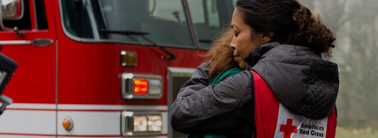 Volunteer hugs home fire victim