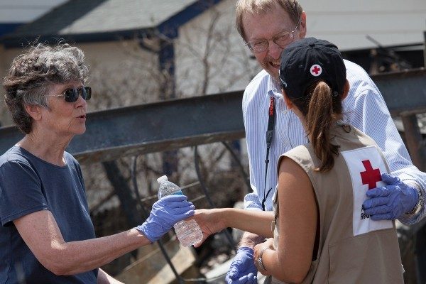 A Red Cross volunteers meets with homeowners after a disaster