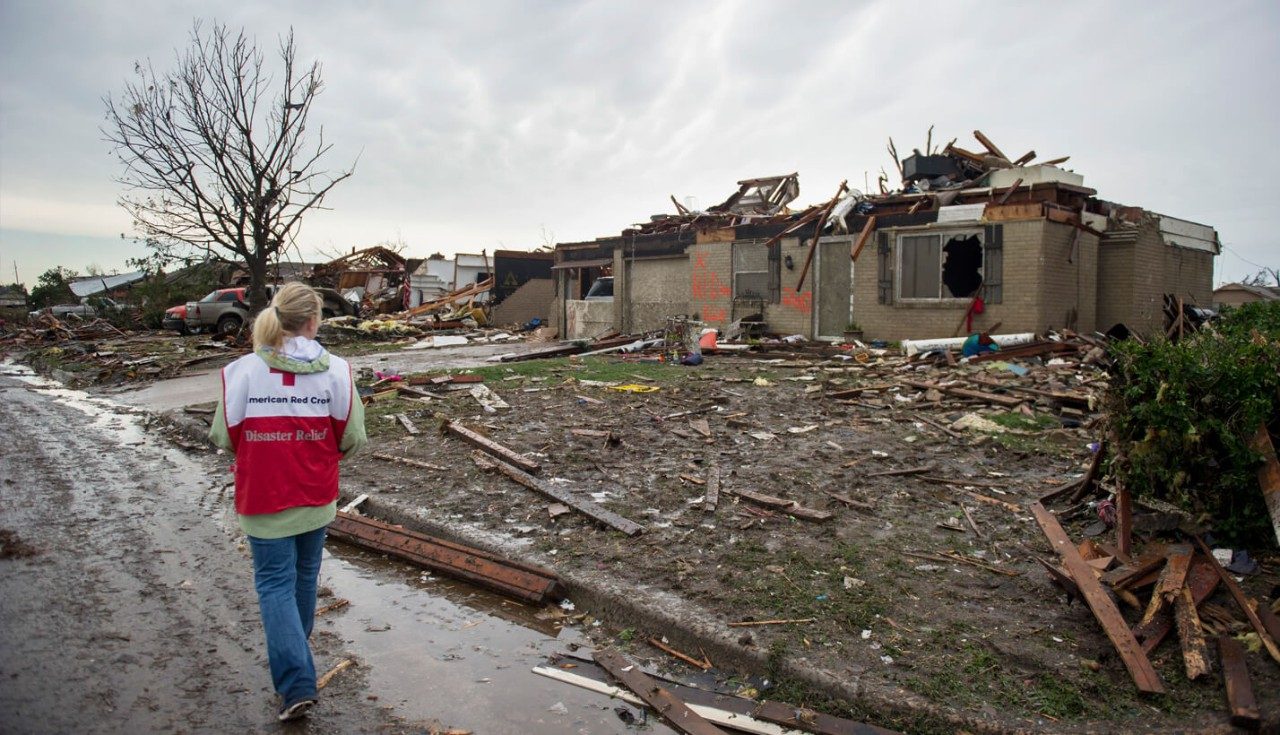 A Red Cross worker surveys the damage caused by the massive tornado.