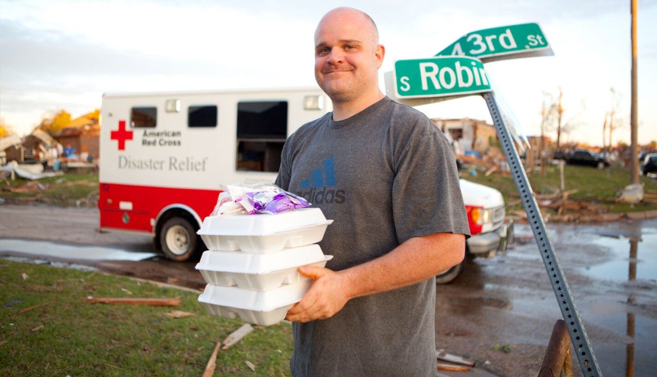 Resident Richard Damron picks up food from a Red Cross disaster relief vehicle.