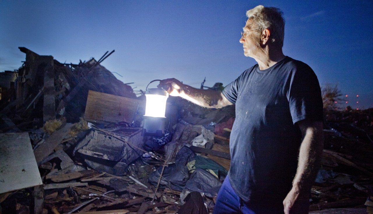Robert Jones, an 80-year-old resident of Oklahoma City, shines his lantern on the remains of his home. 