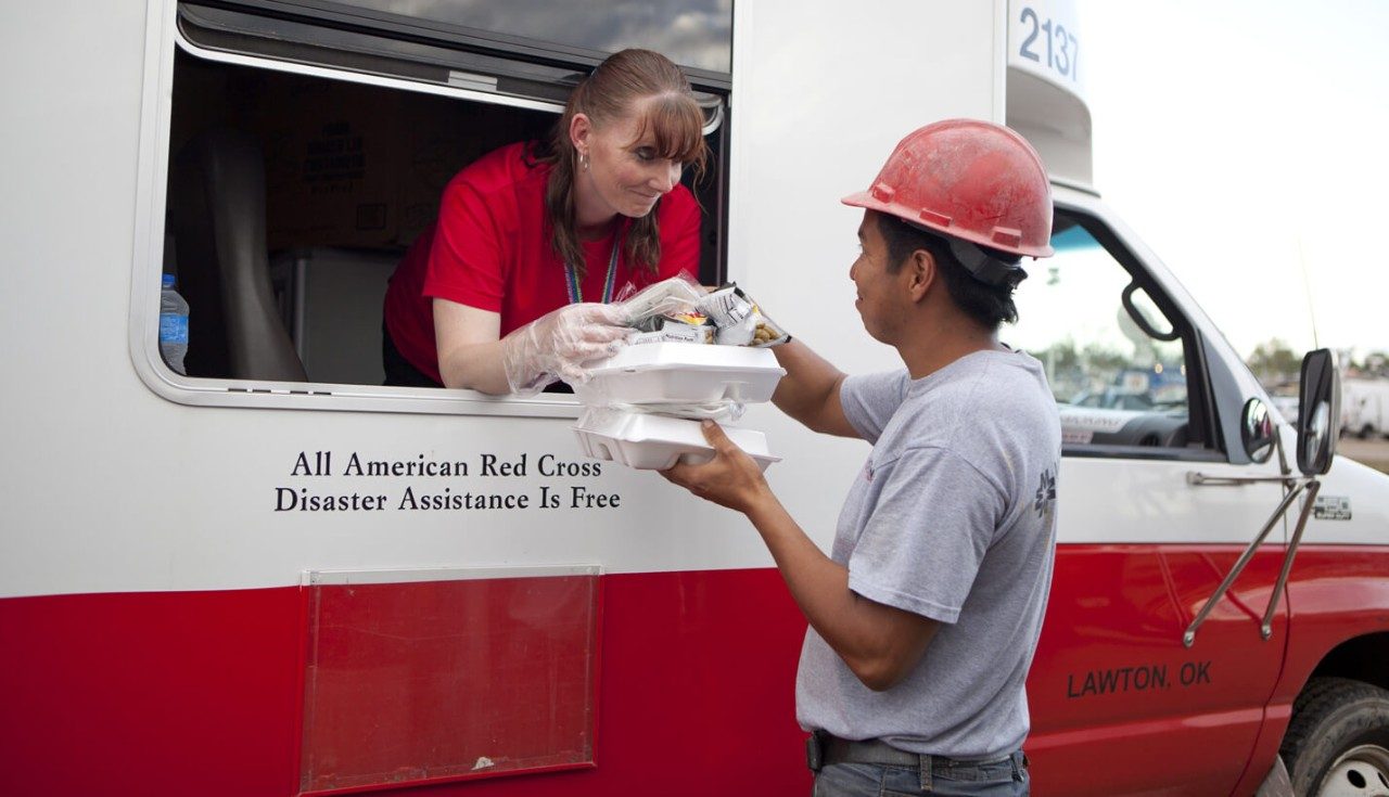 Red Cross volunteer Angela Clemins delivers lunches to workers near a destroyed Moore shopping center.