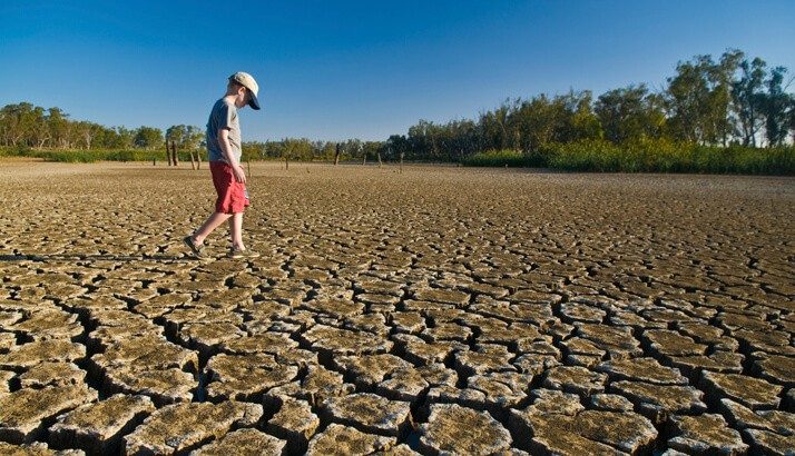 Young boy walking around area in a drought