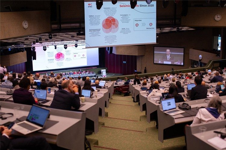 Photo of a large group gathered fo a presentation