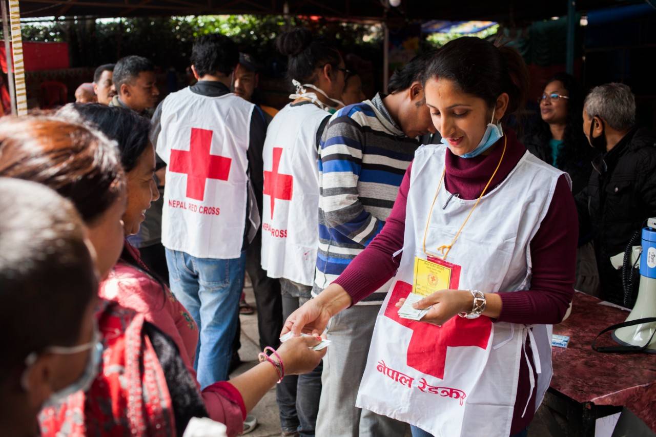 Nepal Redcross volunteer, Manisha Bashyal, 25 yrs distributing water purification tablets Aquatab to the locals living temporarily at camp of Bhaktapur districts, Nepal on Thrusday 30th April, 2015.