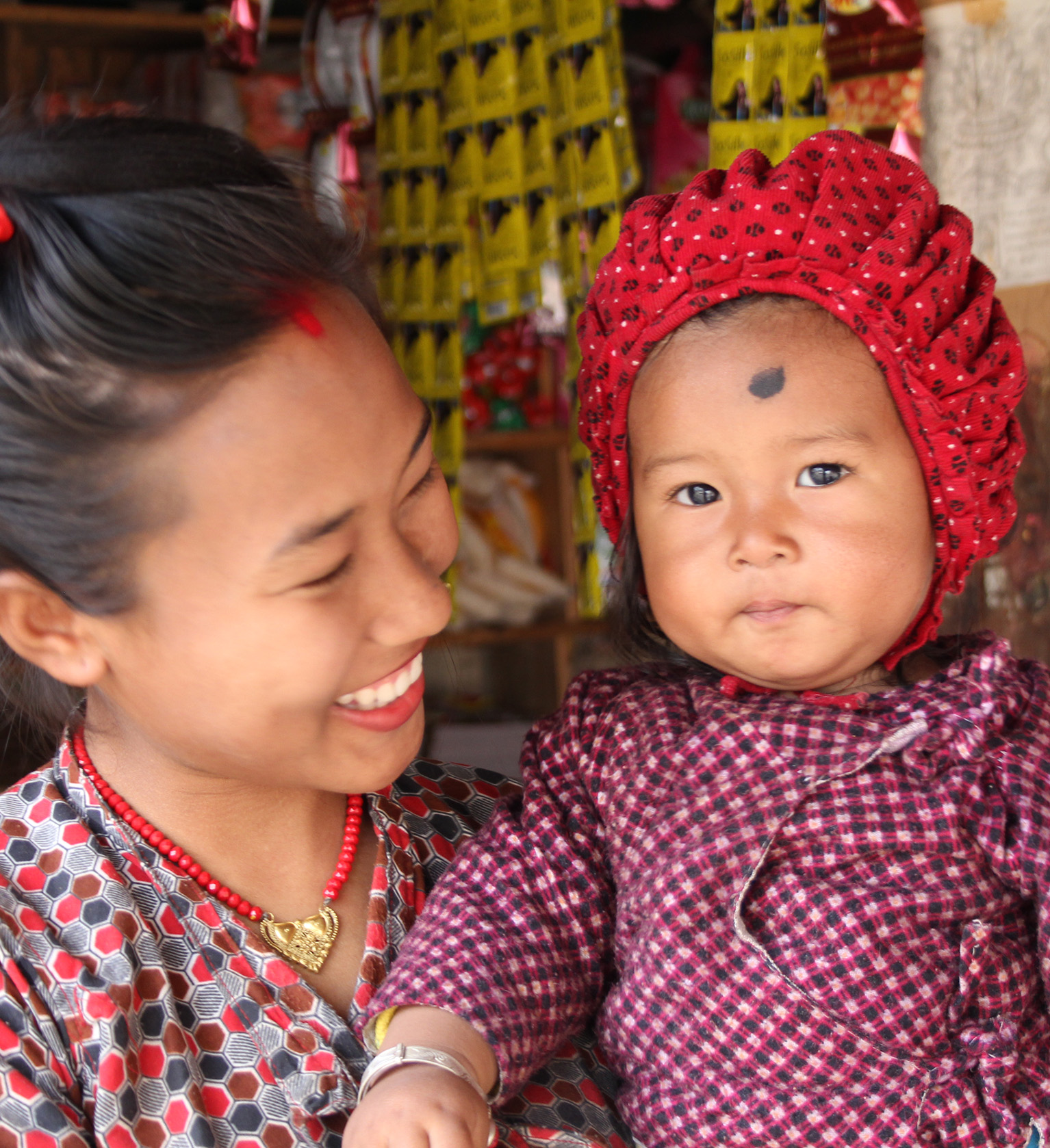 A woman smiling at a child.