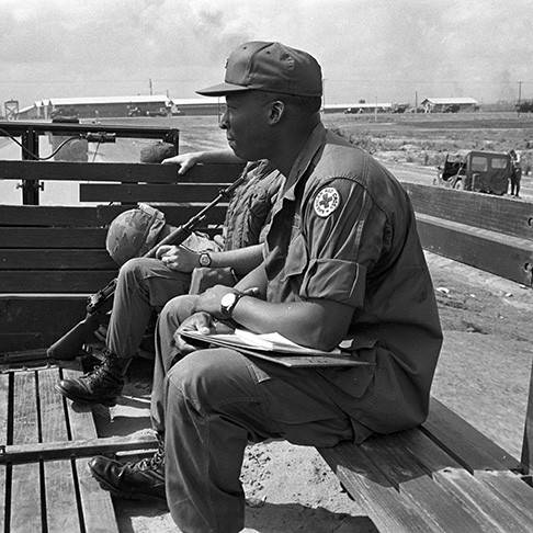 June 1968. Long Binh, Vietnam. Red Cross Field Director Steve Bullock takes advantage of whatever transportation is available to get to scattered units around Long Binh, whether it's a jeep, a helicopter, or a passing truck. Photo by Mark Stevens/American Red Cross.