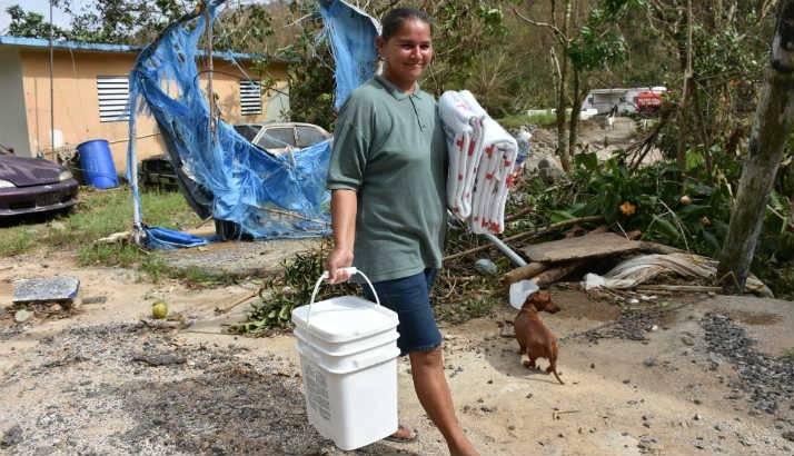 Red Cross volunteers distribute water, food and other basic necessities to families affected by Hurricane Maria.