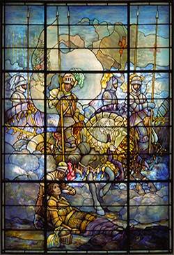 10009_002 - September 7, 2006 - Tiffany Windows at the Board of Governors Hall - Washington D.C. - Photo: Hector Emanuel - no release needed - Central Window --Three beautiful Tiffany windows are located in the elegant Board of Governors Hall at American Red Cross national headquarters in Washington, D.C. They are reputed to be the largest surviving suite of Tiffany windows still in their original location (except for those in churches). The Left Tiffany Window was funded by the Women's Relief Corps of the North. It shows the legendary Saint Filomena, famed for her healing powers, surrounded by women symbolizing different virtues such as hope, mercy, faith, and charity. These virtues are an integral part of the symbolism of the national headquarters building , which was conceived as a "Memorial to the Heroic Women of the Civil War." The first woman pictured in the window carries a shield emblazoned with the Red Cross emblem. Also included in the scene are a mother holding her child and a maiden carrying the Red Cross banner. The Central Tiffany Window, a joint gift from the Women's Relief Corps of the North and the United Daughters of the Confederacy, symbolizes the healing of a formerly divided nation. It portrays an army of gallant knights in armor, mounted on horses and carrying spears. The central figure, astride a white horse bedecked with jeweled trappings, carries a large flag with the Red Cross emblem. An injured warrior lies at the horse's feet and receives food and aid from a compassionate comrade. This scene underscores the Red Cross commitment to provide assistance on the battlefield. The Right Tiffany Window, funded by the United Daughters of the Confederacy, features Una from Edmund Spenser's "Faerie Queene," who represents truth and fortitude. Una's apron is filled with roses--symbols of good deeds. She is accompanied by a maiden holding a cross and another young woman who carries the lamp of wisdom. Behind her are maidens with banners symboli