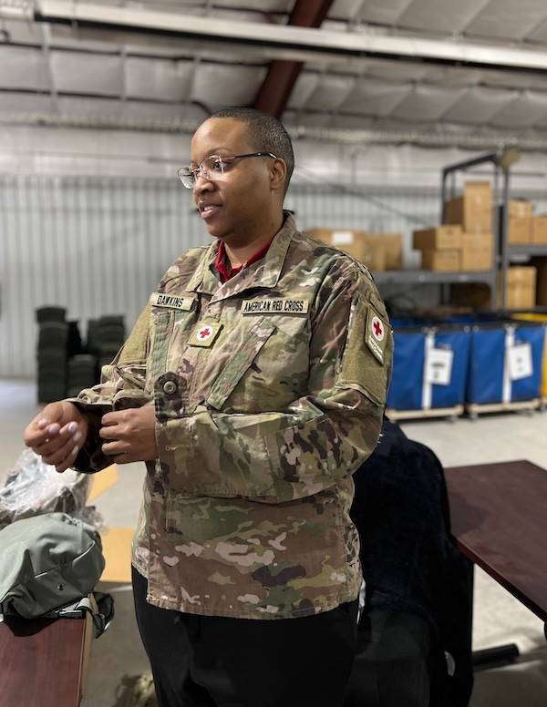 Nailah Dawkins receives equipment and tries gear, including a gas mask, at Camp Atterbury in Indiana.