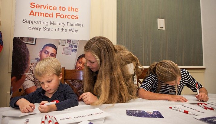 The children of Senator Ben Sasse sign holiday cards during the Holiday Mail for Heroes Event. 