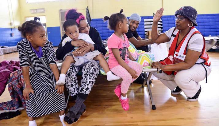 Red Cross Volunteer Talking With Family