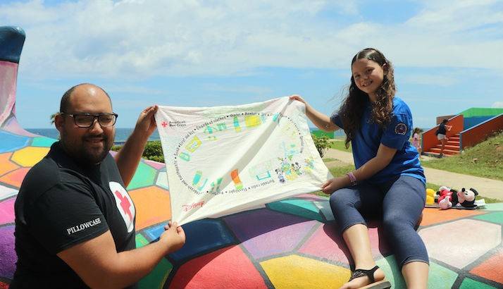 Red Cross volunteer Jeffrey Rodríguez and Britney Rivera showcase some of Britney’s work from the Pillowcase Project.