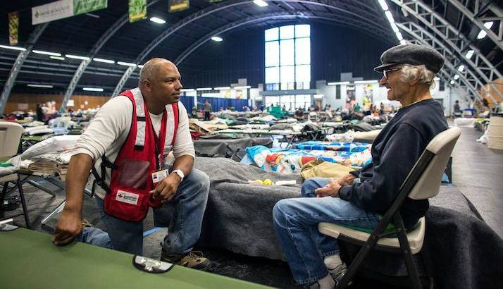 A Red Cross volunteer spends some time with Charles, who took refuge at the Sonoma Fairgrounds shelter.